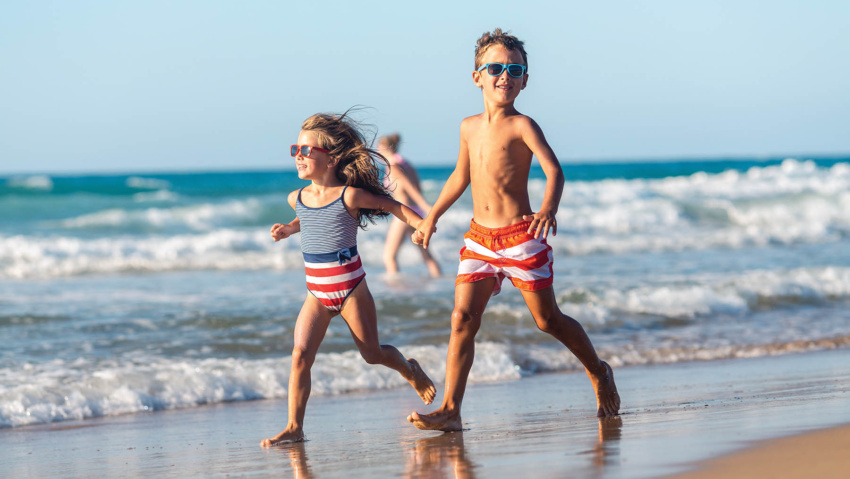 Girl and boy enjoys running on the beach
